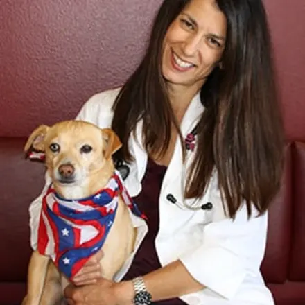 Dr. Monika Scott holding a dog 